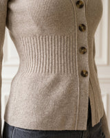 The Harlow Cardi in khaki — close-up of the ribbed waist detail and side buttons