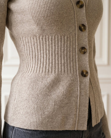 The Harlow Cardi in khaki — close-up of the ribbed waist detail and side buttons