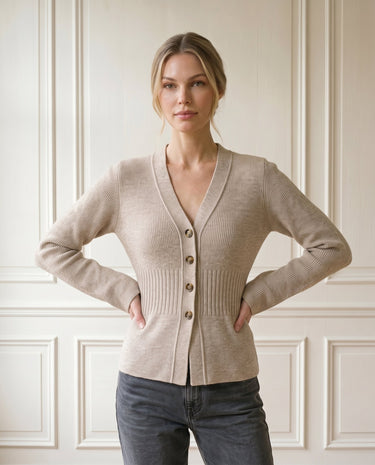 The Harlow Cardi in khaki — V-neck button-front knit cardigan, front view on model with hands on hips