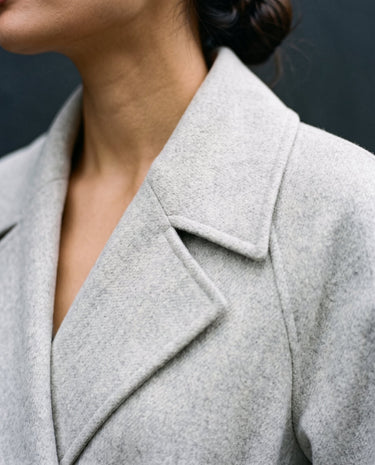 The Haven Tie Waist Coat in light gray — close-up of the lapel collar and shoulder
