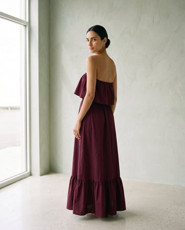 The Ivy Maxi in burgundy — strapless tiered maxi dress, back view on model