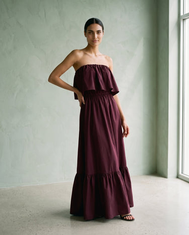 The Ivy Maxi in burgundy — strapless tiered maxi dress, side view on model