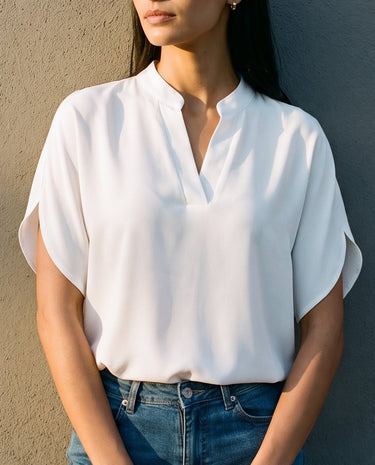 Close front view of the white blouse worn tucked into blue jeans – Moriel Heritage