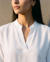 Close-up of the blouse's stand collar and split V neckline – Moriel Heritage