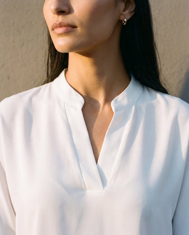 Close-up of the blouse's stand collar and split V neckline – Moriel Heritage