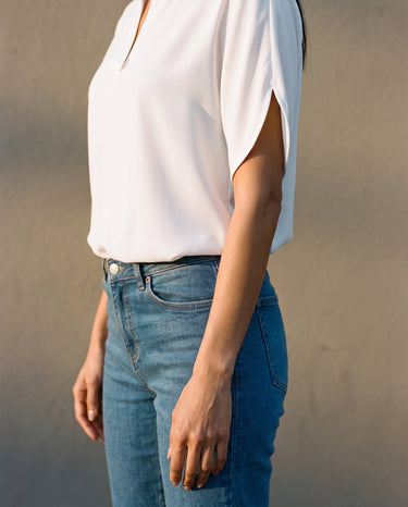 Close-up of the blouse's split cap sleeve and draped body – Moriel Heritage