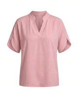 Pink short-sleeve blouse with a stand collar and split V neckline, flat lay on white – Moriel Heritage