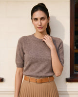 The Kyla short-sleeve knit tee in taupe — front view with hand near neckline on model