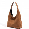The Léa Slouch Tote in brown suede, three-quarter studio view showing the slouched body and single wide shoulder strap