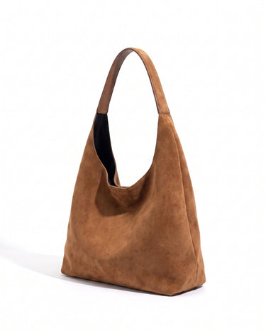 The Léa Slouch Tote in brown suede, three-quarter studio view showing the slouched body and single wide shoulder strap