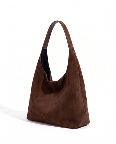 The Léa Slouch Tote in coffee suede, three-quarter studio view on a white background