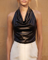 Close front view of the black cowl-neck halter top worn with cream trousers – Moriel Heritage