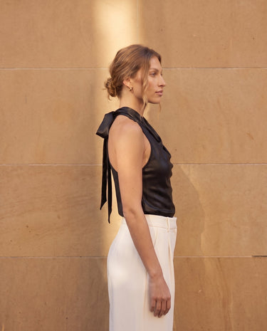 Side view of the black cowl-neck halter top showing the open back – Moriel Heritage