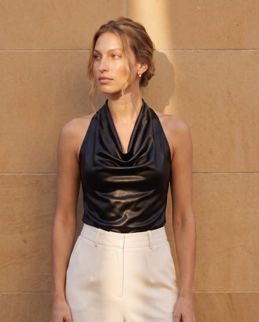 Model in the black cowl-neck halter top, angled front view – Moriel Heritage