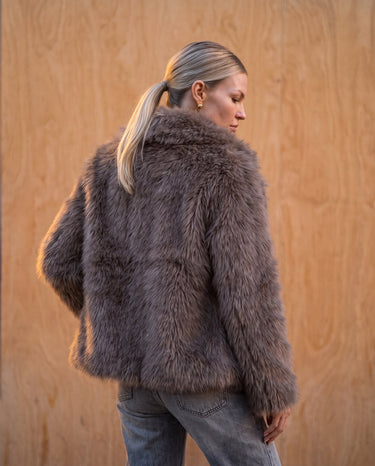 Side and back view of the dark brown faux fur Lira Jacket showing the dropped shoulder and full sleeve