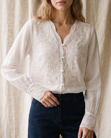 The Lirielle Cotton Blouse in white — sheer cotton blouse with lace trim, front view on model