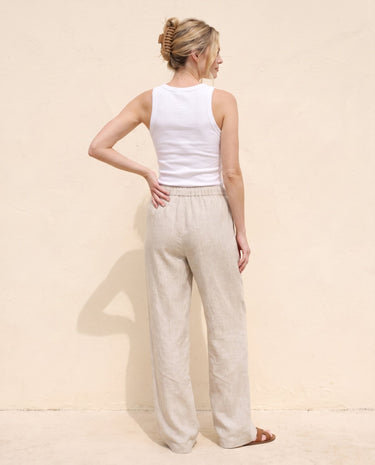 The Loelia Linen Pants in natural linen — wide-leg linen trousers, back view on model