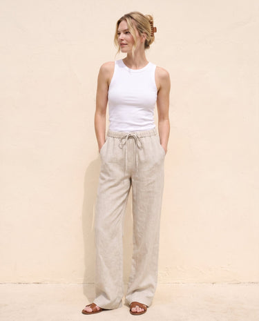 The Loelia Linen Pants in natural linen — wide-leg linen trousers, full-length front view on model