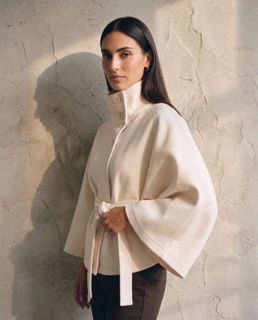 The Lorenne coat in white — side view on model