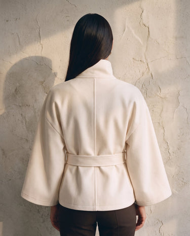 The Lorenne coat in white — back view on model