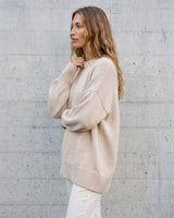 The Lorna knit pullover in beige — side view on model