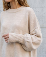 The Lorna knit pullover in beige — close-up of the ribbed cuff and dropped shoulder