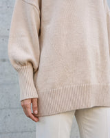The Lorna knit pullover in beige — close-up of the ribbed hem and side detail
