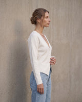 The Maisonette Cardigan in white — side view on model