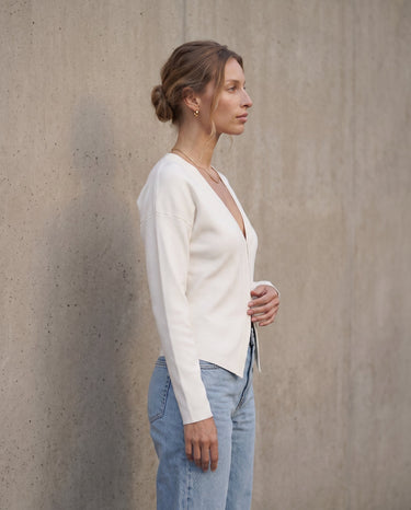 The Maisonette Cardigan in white — side view on model