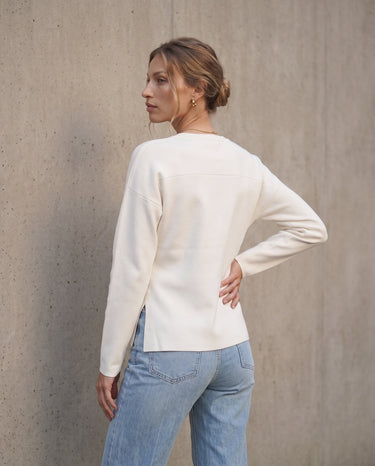 The Maisonette Cardigan in white — back three-quarter view on model