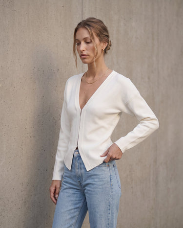 The Maisonette Cardigan in white — front three-quarter view on model