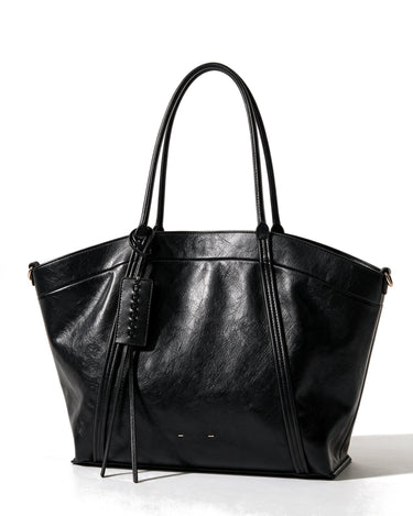 The Marais Carryall in black, front view on a pure white studio background showing the flared tote shape and whipstitched tag