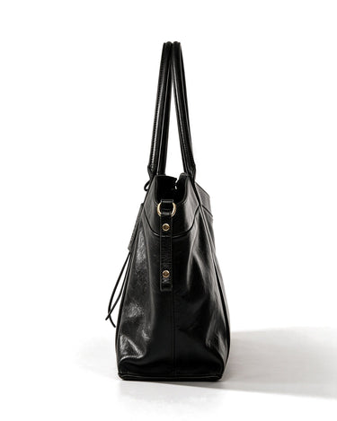 The Marais Carryall in black, side profile view showing the gusseted depth and buckle
