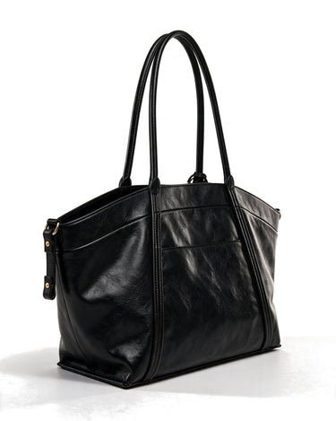 The Marais Carryall in black, rear view showing the plain back panel and side zips