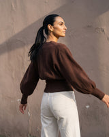 The Marley Cardigan in brown — back three-quarter view on model