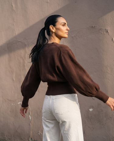 The Marley Cardigan in brown — back three-quarter view on model
