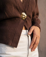 The Marley Cardigan in brown — close-up of the button and ribbed waist