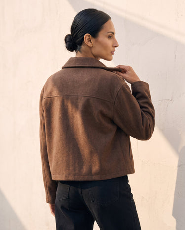 The Maude jacket in brown — back view on model