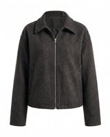 The Maude jacket in black — zip-front collared jacket with a structured silhouette, product flat-lay