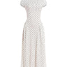 The Maura Polka Dot Dress in cream — cap-sleeve high-neck polka dot maxi dress, product flat-lay