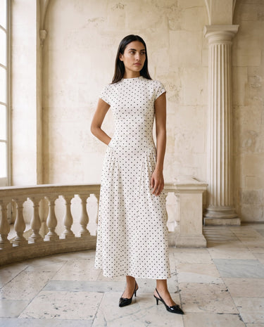 The Maura Polka Dot Dress in cream — cap-sleeve polka dot maxi dress, front view on model