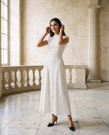 The Maura Polka Dot Dress in cream — cap-sleeve polka dot maxi dress, front view on model