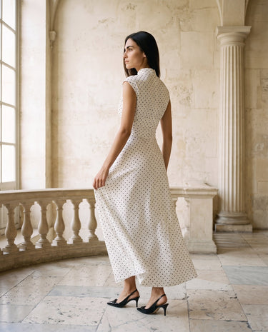 The Maura Polka Dot Dress in cream — polka dot maxi dress, back view on model
