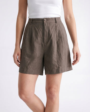 The Mauria Linen Shorts in cocoa — high-waisted pleated linen shorts, front view on model