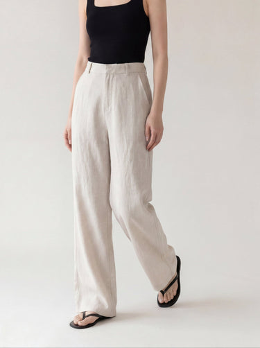 The Miela Linen Blend Pant in oat — wide-leg linen-blend trousers, walking view on model