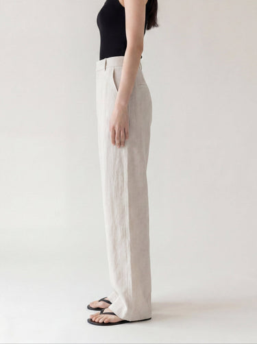 The Miela Linen Blend Pant in oat — wide-leg linen-blend trousers, side profile on model