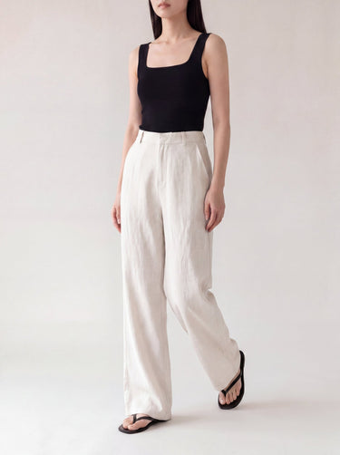 The Miela Linen Blend Pant in white — wide-leg linen-blend trousers, walking view on model