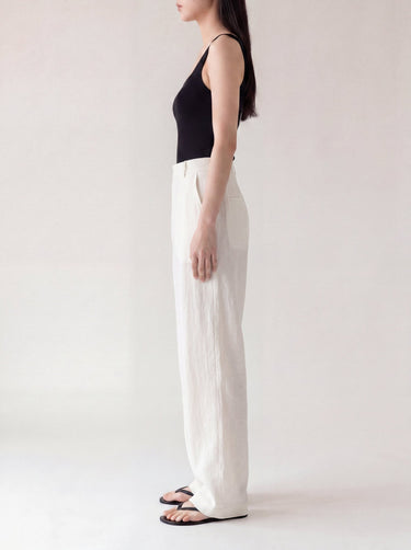 The Miela Linen Blend Pant in white — wide-leg linen-blend trousers, side profile on model