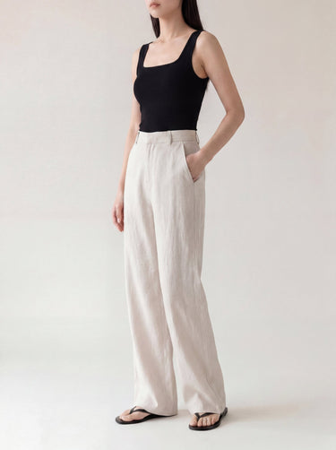 The Miela Linen Blend Pant in white — wide-leg linen-blend trousers, three-quarter view on model