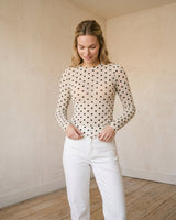 The Milly Polka Dot Sheer Top in cream — sheer polka dot mesh top, front styling view on model